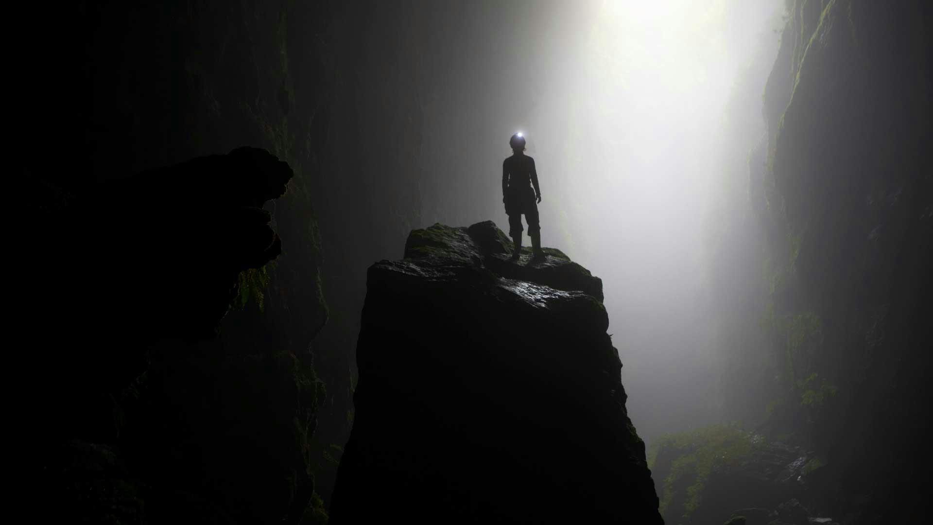 Person standing in a cavern in The Waitomo Caves