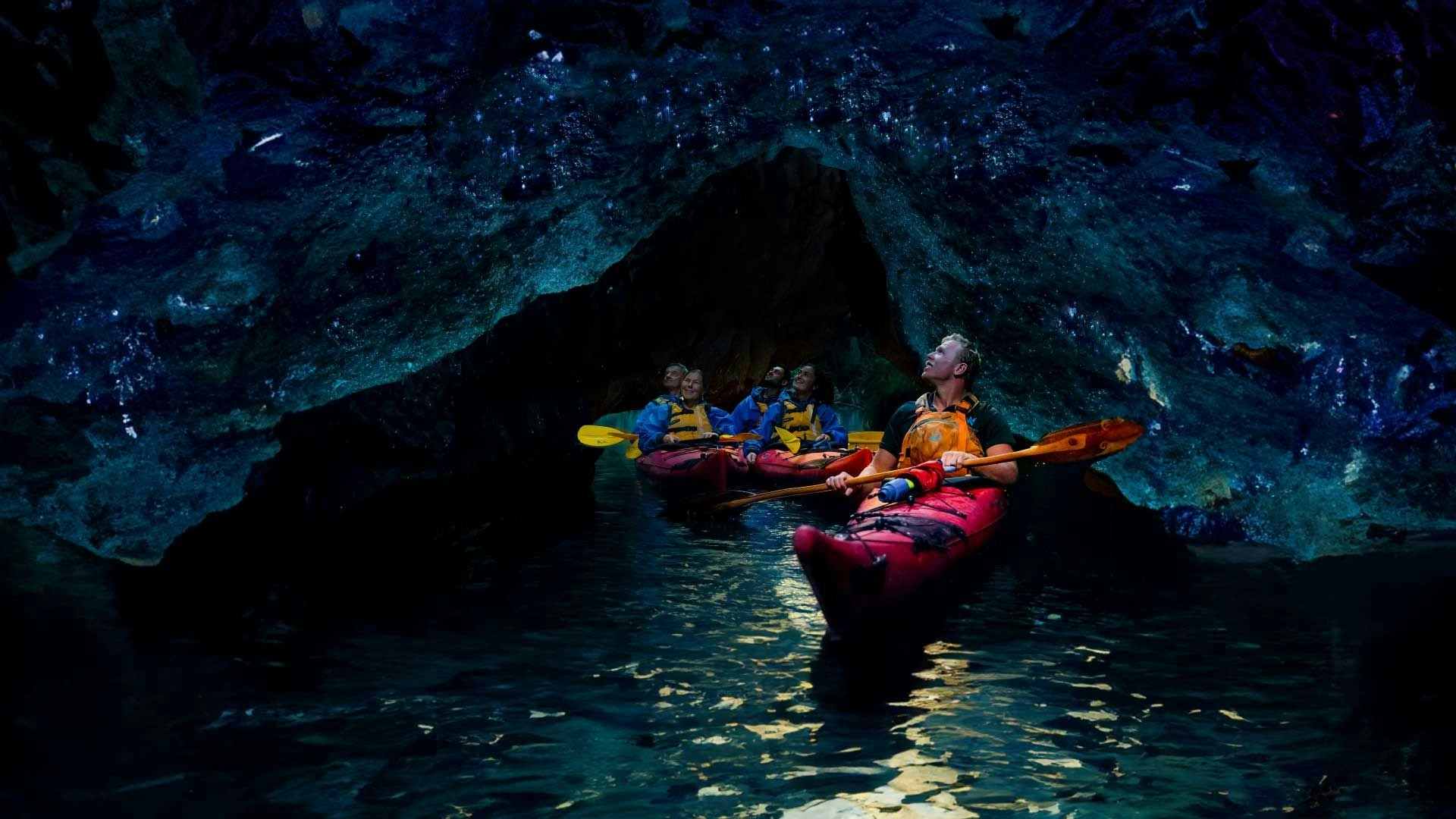 Group of kayakers in a glowworm cave