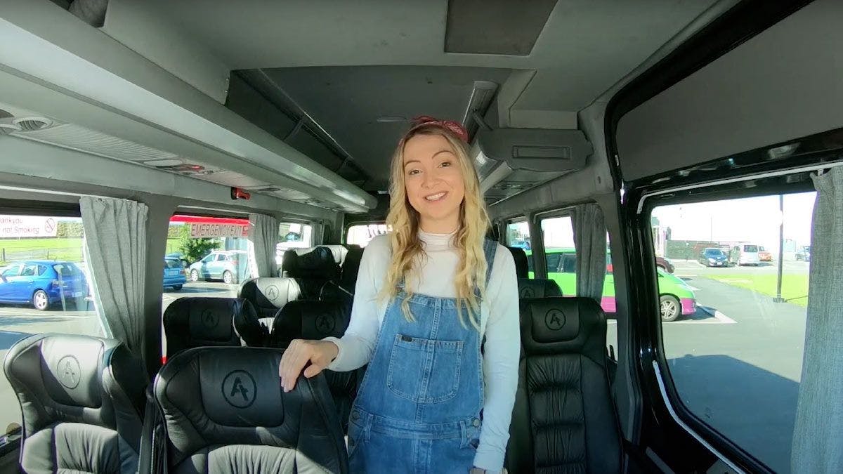 Woman standing inside a Wild Kiwi Tours bus