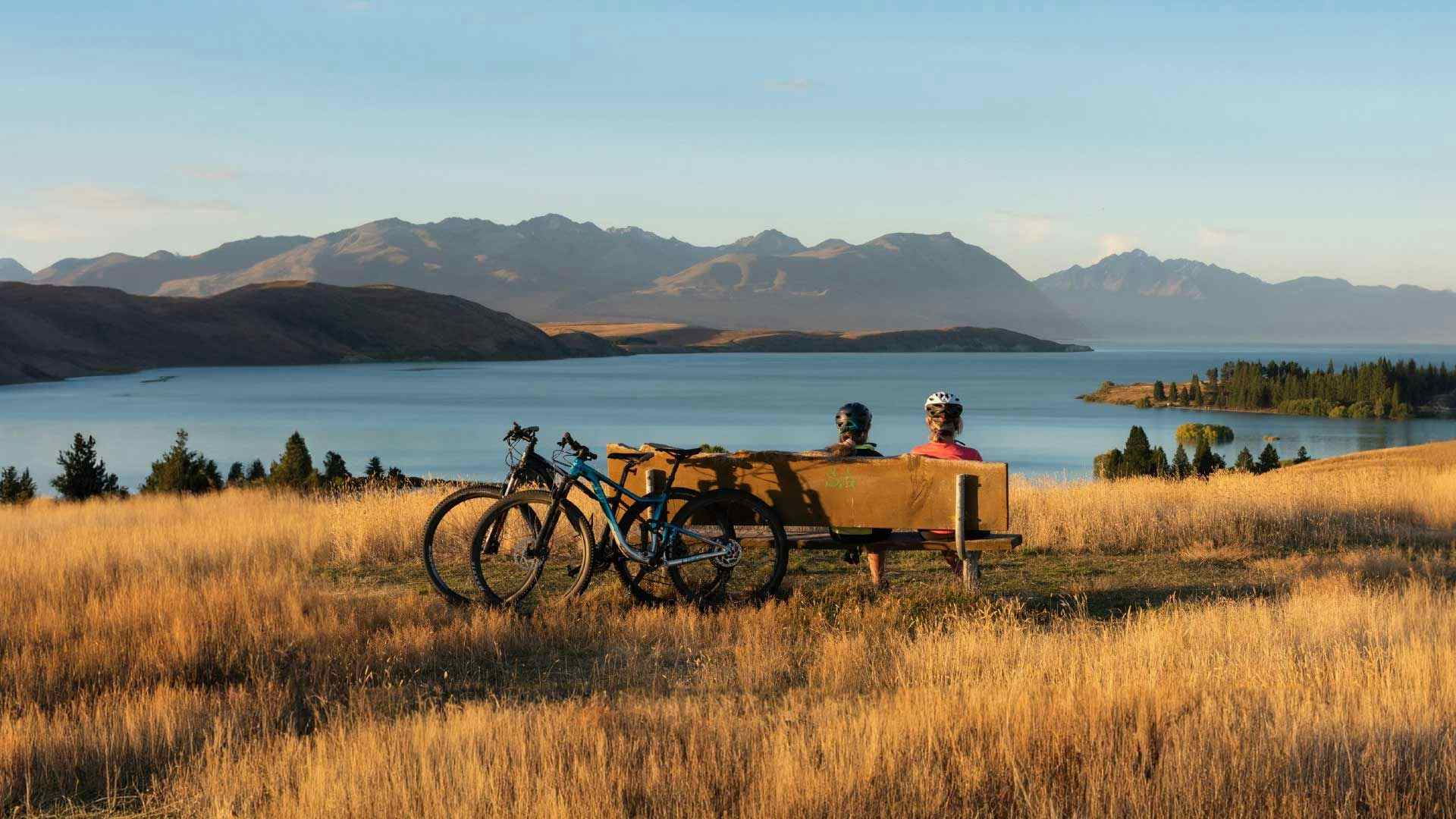 Two cyclists admire the view at Lake Tekapo