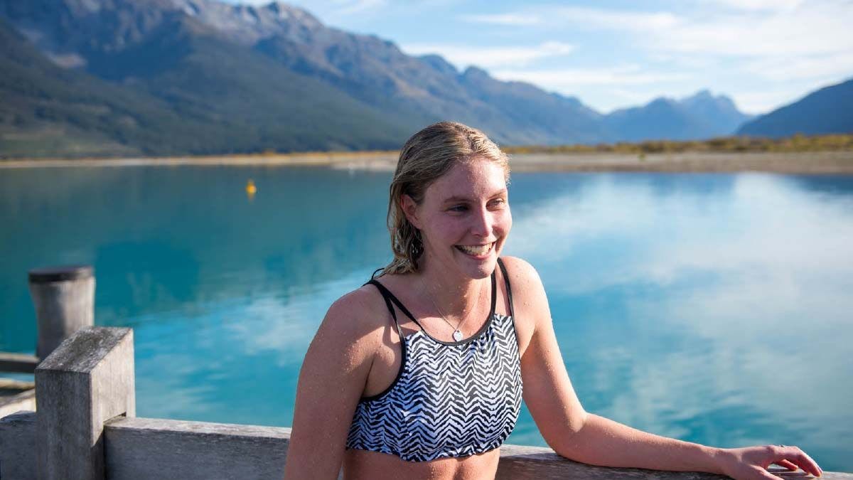 Young woman posing for a photo in front of Lake Wakatipu